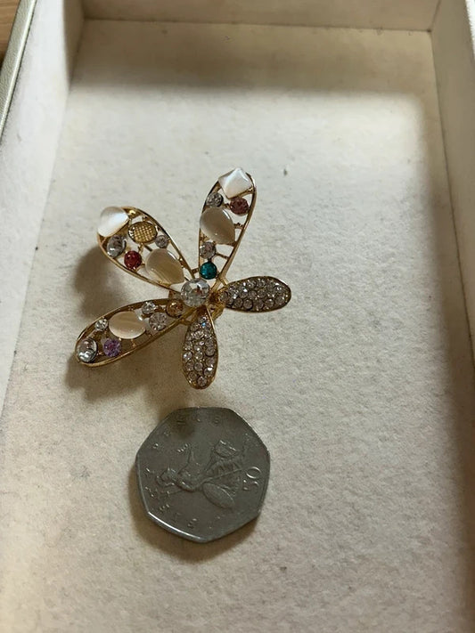 gold crystal floral brooch with pearl style stones