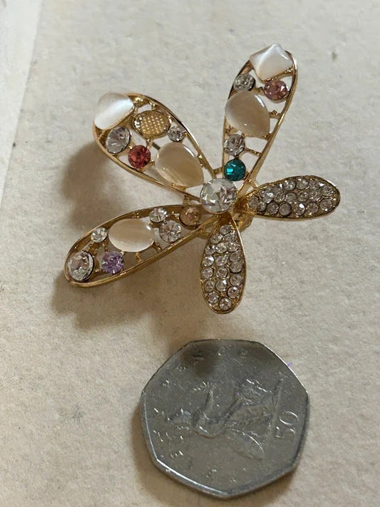 gold crystal floral brooch with pearl style stones