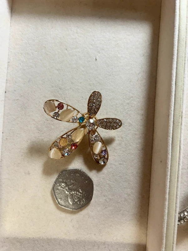 gold crystal floral brooch with pearl style stones
