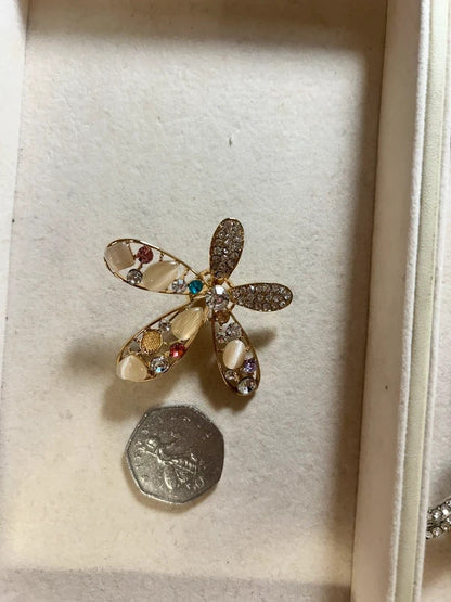 gold crystal floral brooch with pearl style stones