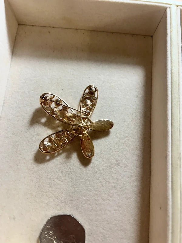 gold crystal floral brooch with pearl style stones