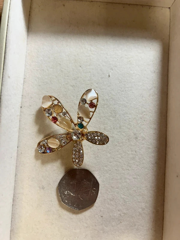gold crystal floral brooch with pearl style stones